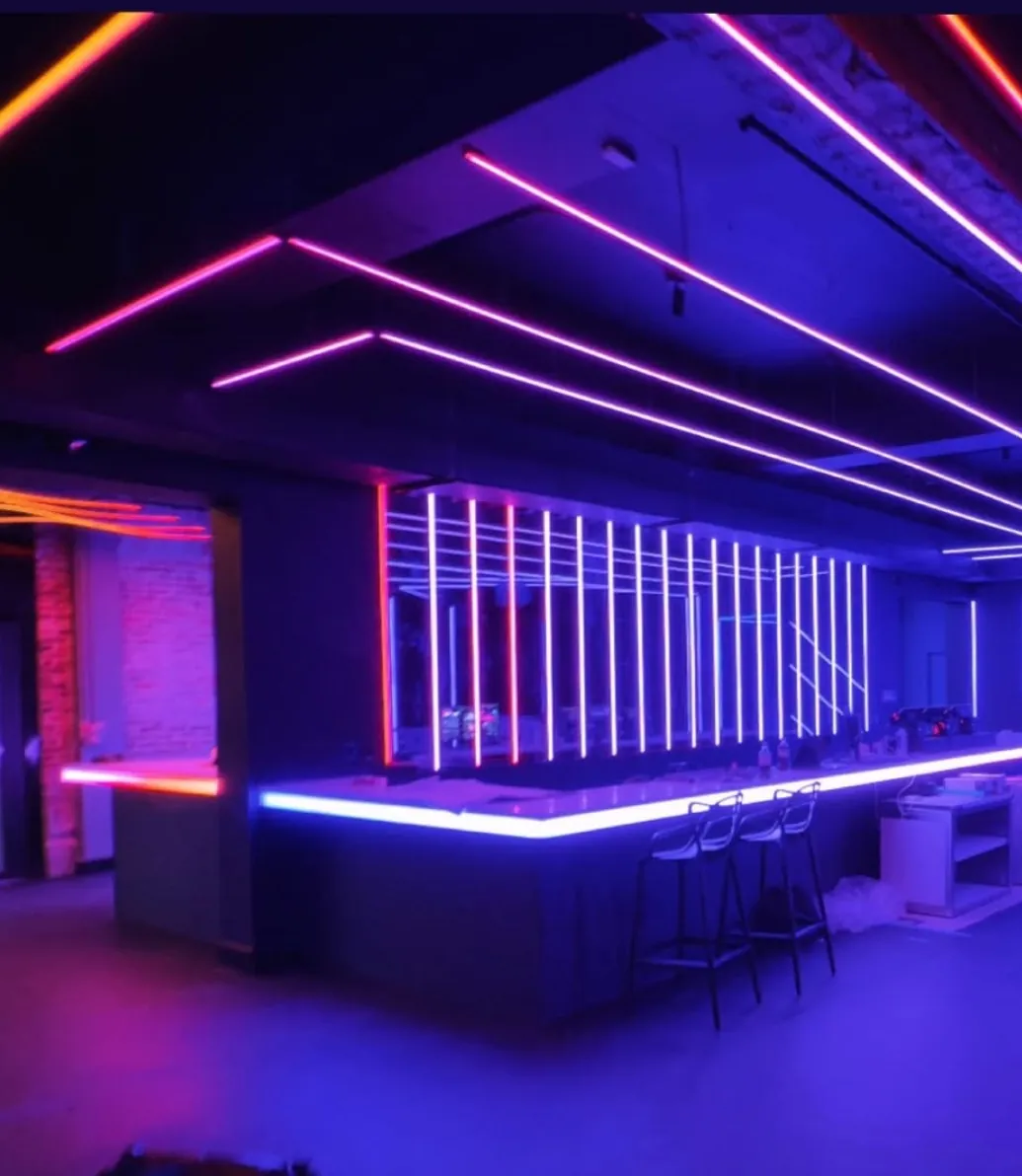 The finished bar at Anthem Orlando with purple and pink neon line lighting