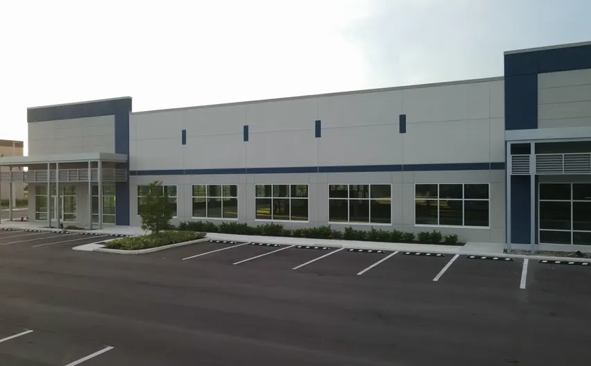 A new single-storey commercial building with grey panels and navy accents